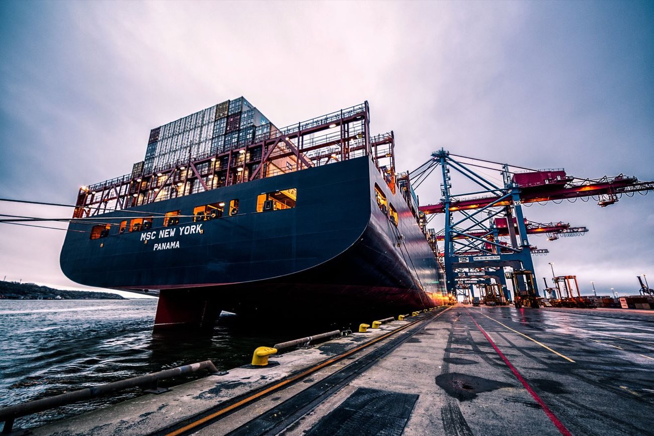 Container ship berthed at a busy port terminal